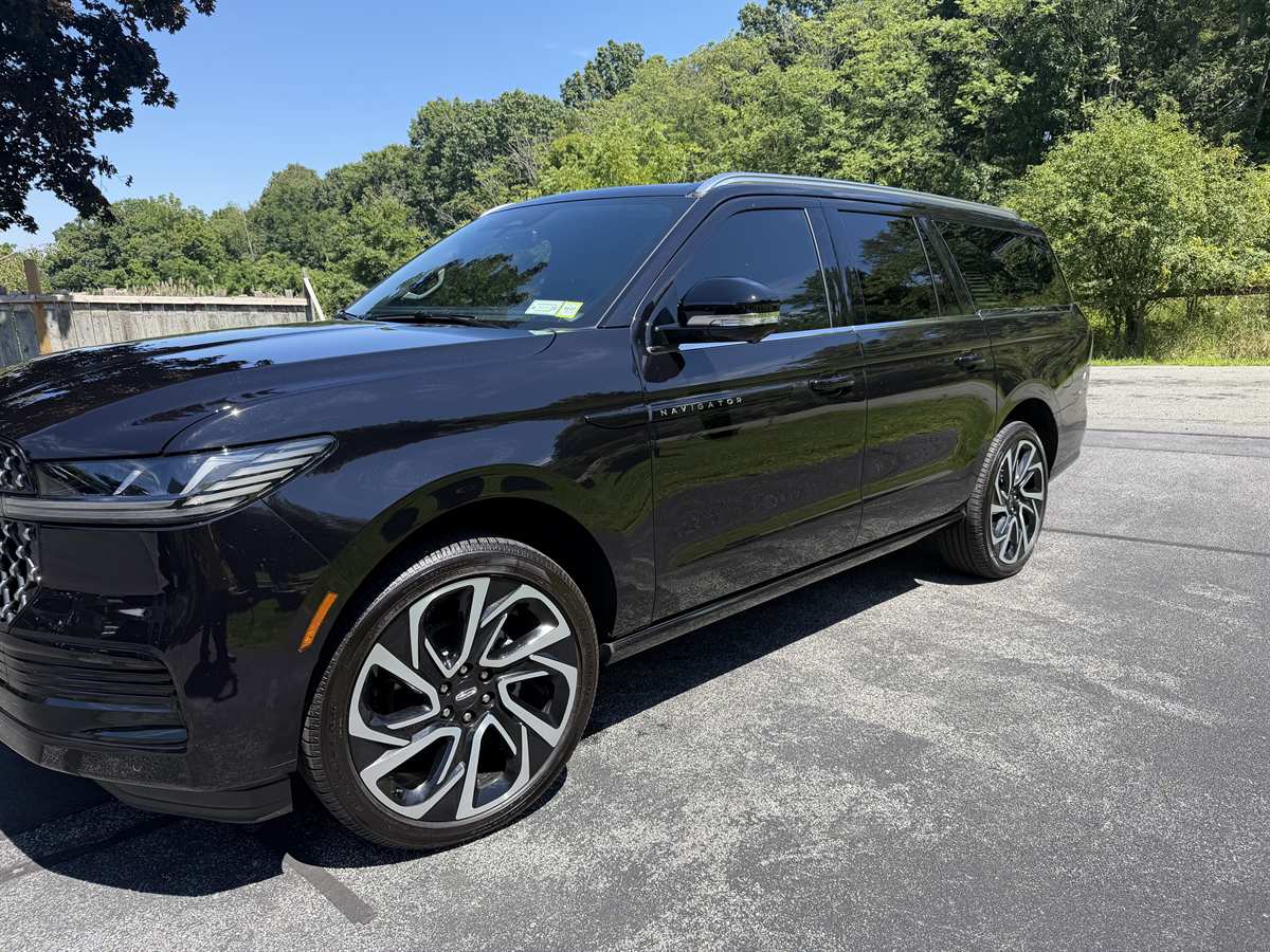 Black Lincoln Navigator SUV, front three-quarter view - 123 Limo