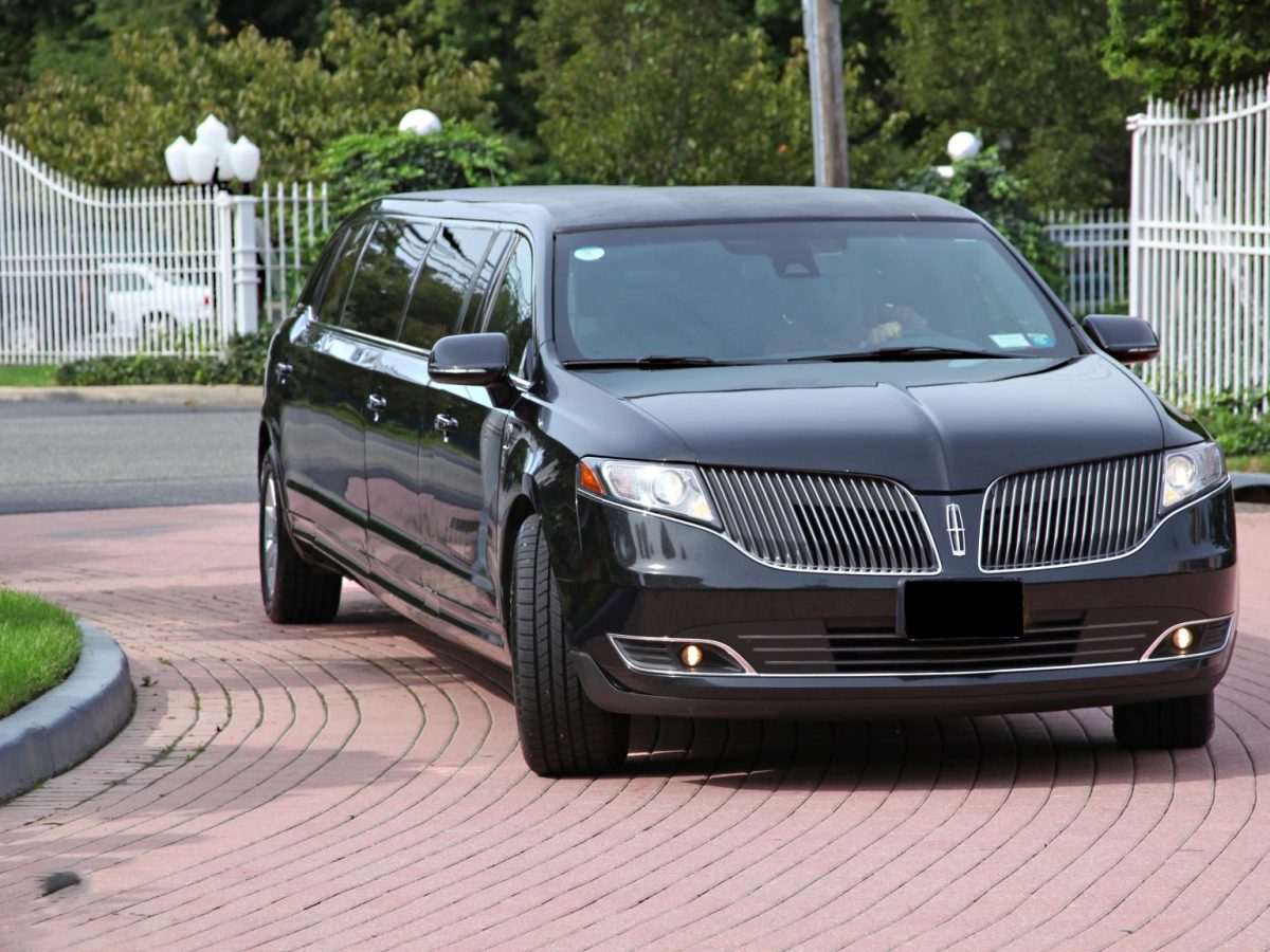 Black Lincoln MKT stretch limousine, front three-quarter view - 123 Limo