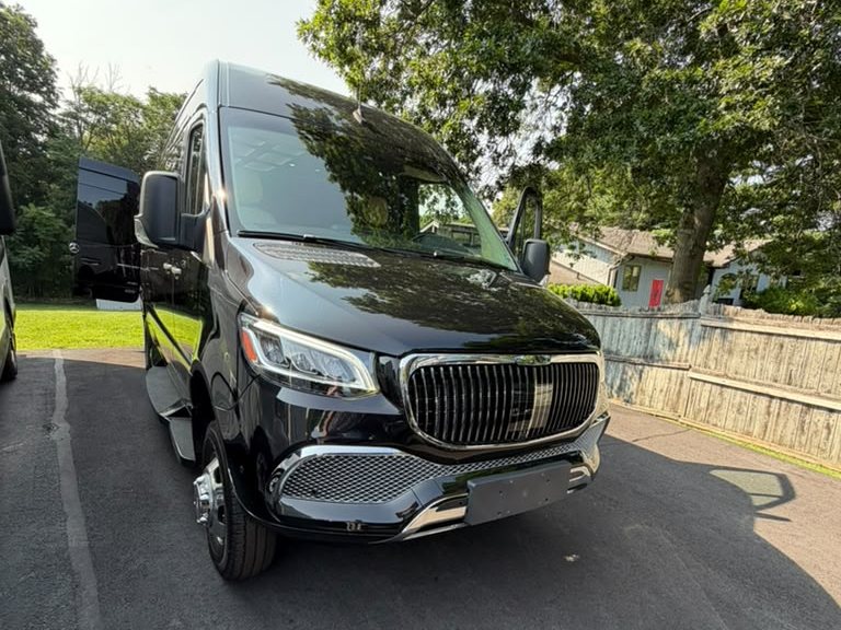 Black Mercedes-Benz Sprinter executive coach, front three-quarter view - 123 Limo